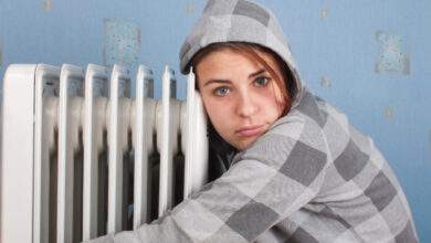 Une jeune fille est assise près du chauffage