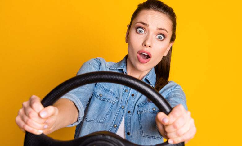 Une femme au volant sur fond jaune