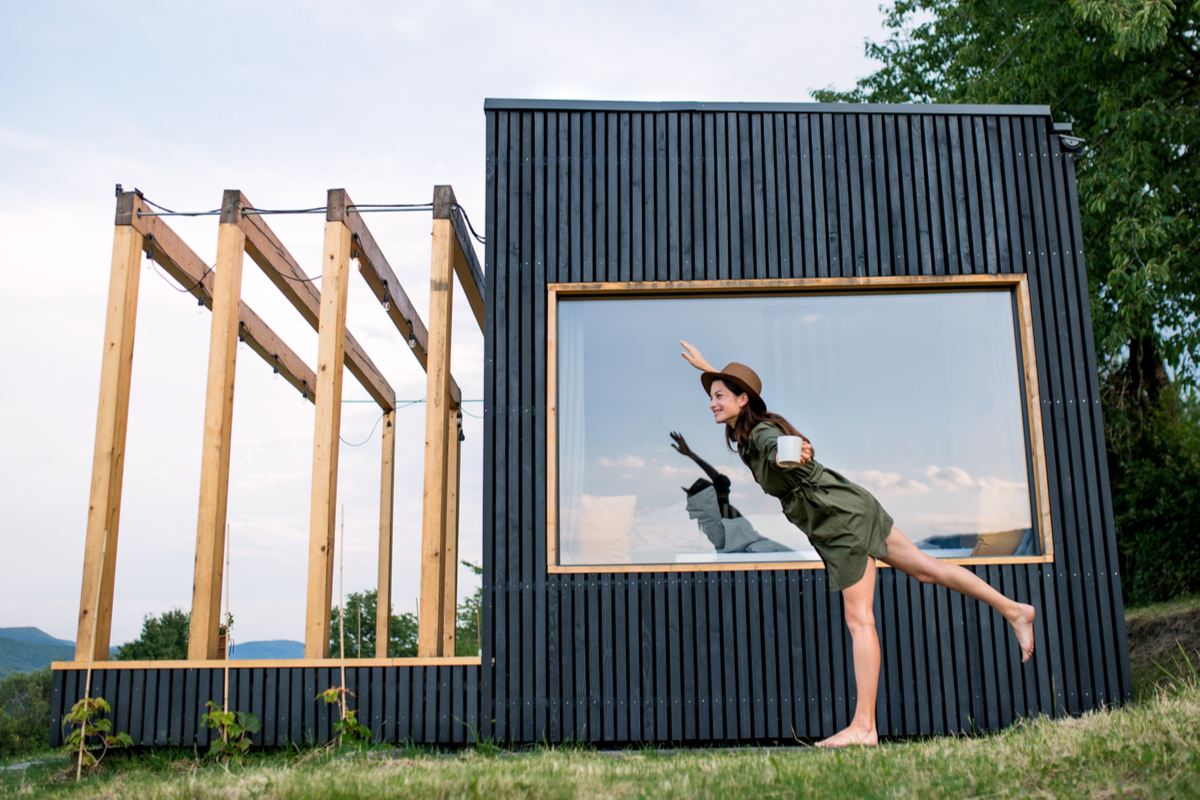 Une femme devant une maison container