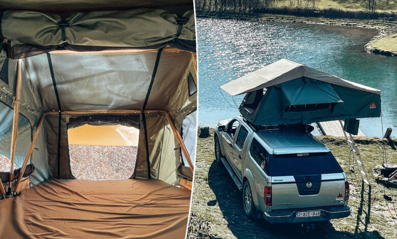 Une voiture sur le bord d'un lac avec une tente de toit