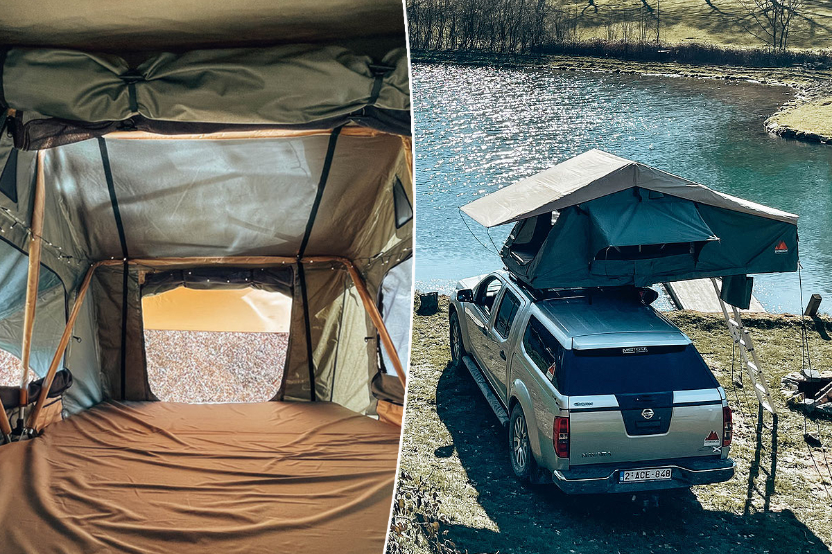 Une voiture sur le bord d'un lac avec une tente de toit