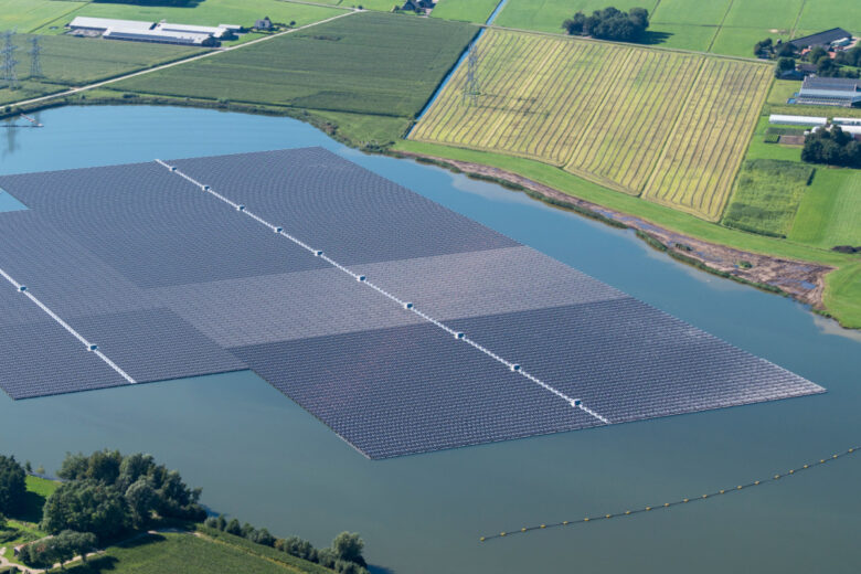 Vue aérienne de panneaux solaires flottants sur un lac.