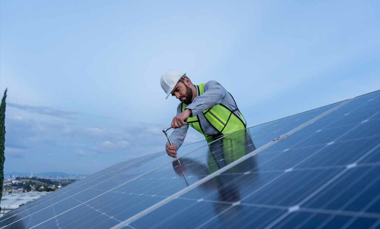 Un technicien qui installe des panneaux solaires.