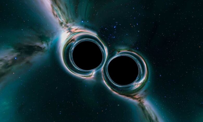Deux trous noirs qui fusionnent dans l'espace.