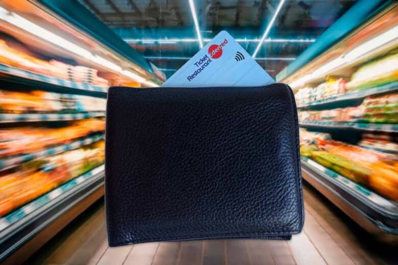 Un portefeuille avec une carte ticket restaurant dans un rayon de supermarché.