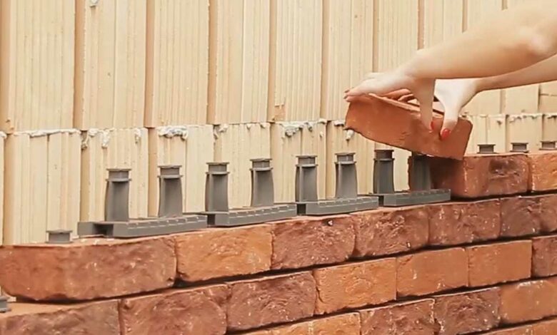Une femme construit un mur en brique avec Facadeclick.