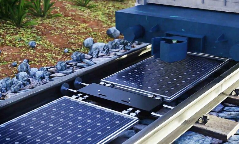 Installation de panneaux solaires entre les voies de chemin de fer.