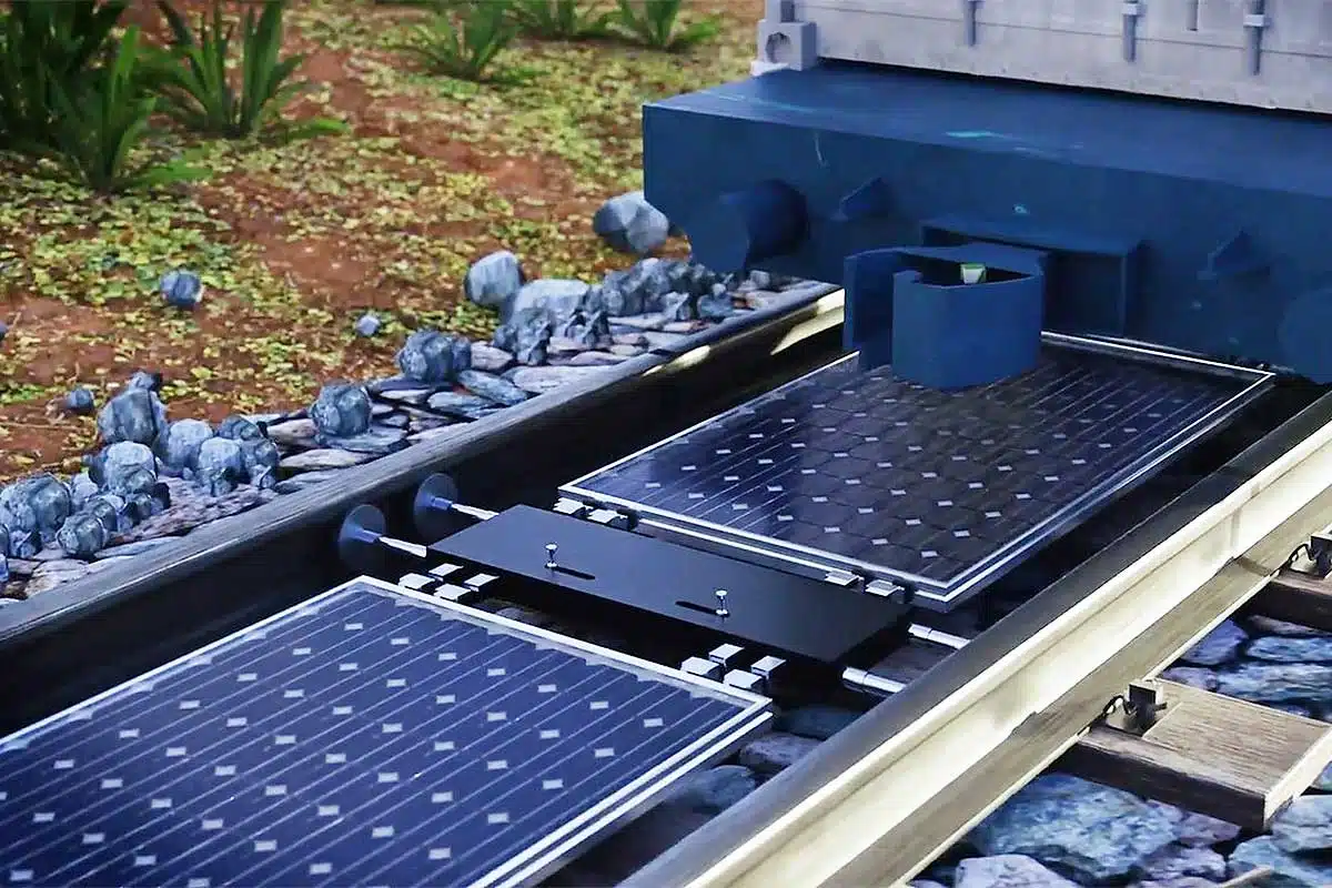 Installation de panneaux solaires entre les voies de chemin de fer.