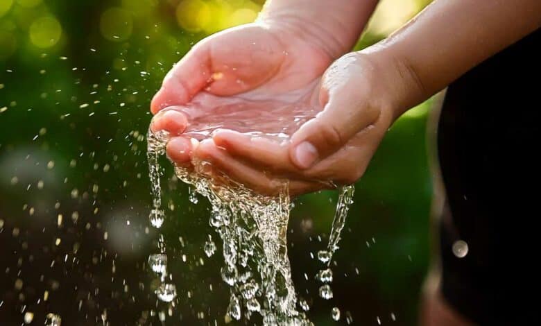 De l'eau dans les mains qui coule.