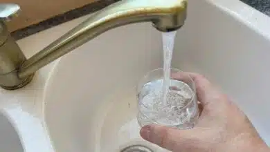 Une personne se verse un verre d'eau du robinet.