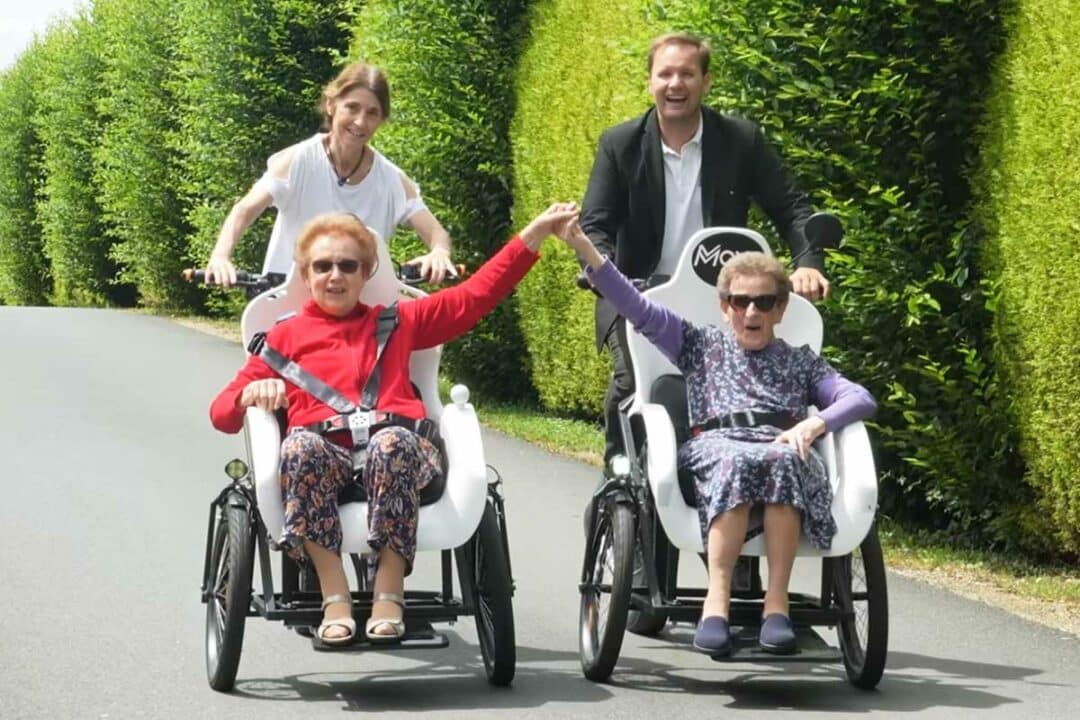 Des séniors en balade sur un triporteur.