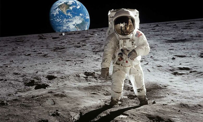 Un astronaute marche sur la Lune avec la Terre en fond.