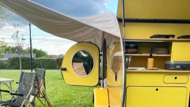 Une mini caravane rétro avec un auvent.