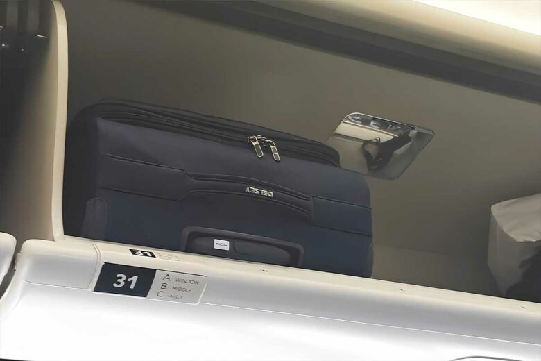 Un bagage cabine dans le compartiment de rangement.