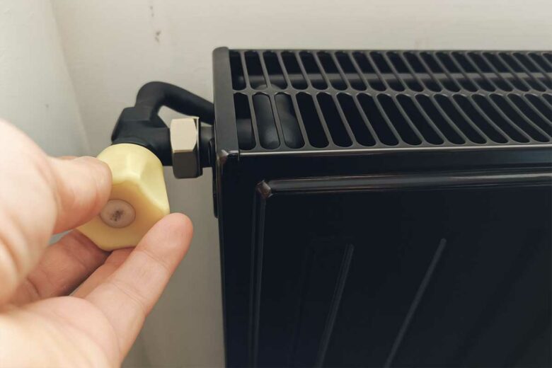 Une personne met en route un chauffage.