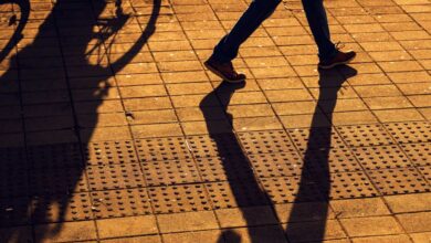 Un piéton et un cycliste partagent le trottoir.