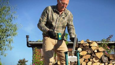Un homme fend des bûches.