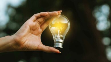 Une femme tient une ampoule.