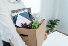 Une personne avec ses affaires quitte ton poste.